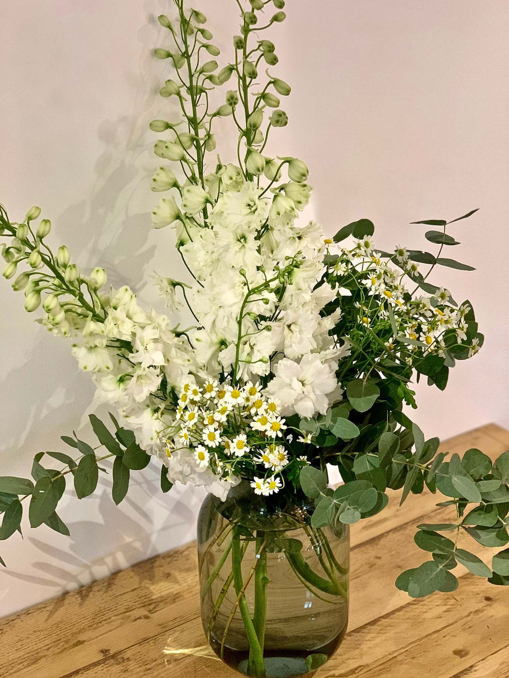 Elise bouquet by Margot Floral Design. A fresh flower bouquet composed of White Delphinium, Mini Daisy, ans Eucalyptus.