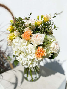 Gabriella bouquet by Margot Floral Design. A fresh flower bouquet composed of Pink Roses, White Hydrangeas, Orange and Yellow Carnations. Medium size.