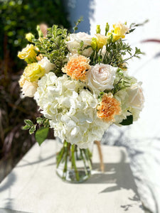 Gabriella bouquet by Margot Floral Design. A fresh flower bouquet composed of Pink Roses, White Hydrangeas, Orange and Yellow Carnations. Medium size.
