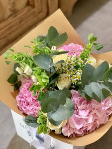 Hermione bouquet by Margot Floral Design. A fresh flower bouquet composed of White O'Hara Garden Roses, Pink Hydrangeas, and Eucalyptus. Medium size.