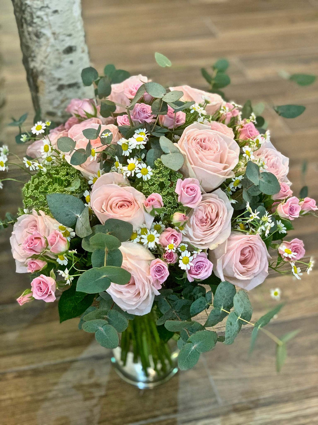 Louise bouquet by Margot Floral Design. A fresh flower bouquet composed of Pink O'Hara Garden Roses, Pink Baby Roses, Mini Daisy, Ammi, and Eucalyptus. Medium size.
