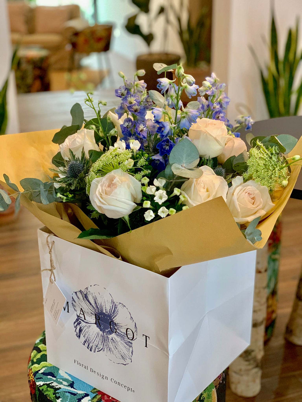 Margot bouquet by Margot Floral Design. A fresh flower bouquet composed of White O'Hara Garden Roses, Blue Delphinium, White Bouvardia, Ammi, and Eucalyptus.