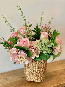 Romane bouquet by Margot Floral Design. A fresh flower bouquet composed of Soft Pink Hydrangea, Soft Pink Garden Roses, White Delphinium, Wax, Ammi, Limonium, and Greeneries. Meduim size.