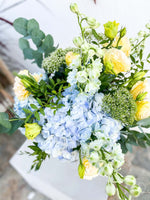 Load image into Gallery viewer, Valentine bouquet by Margot Floral Design. A fresh flower bouquet composed of Pale Yellow Roses, White Delphinium, Blue Hydrangea, and Eucalyptus. Large Size.
